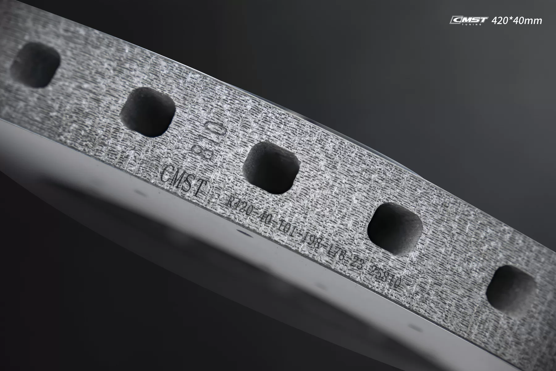 Part number etched into the edge of a CMST carbon-ceramic brake disc