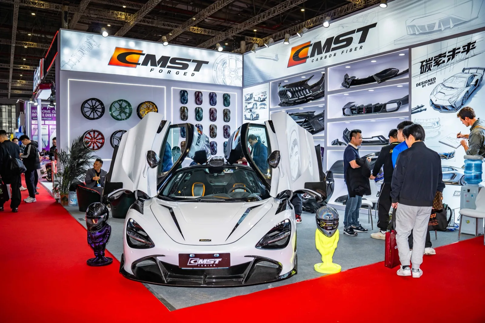 The CMST stand at Automechanika Shanghai, a white McLaren 720S with its doors up in front of the product wall